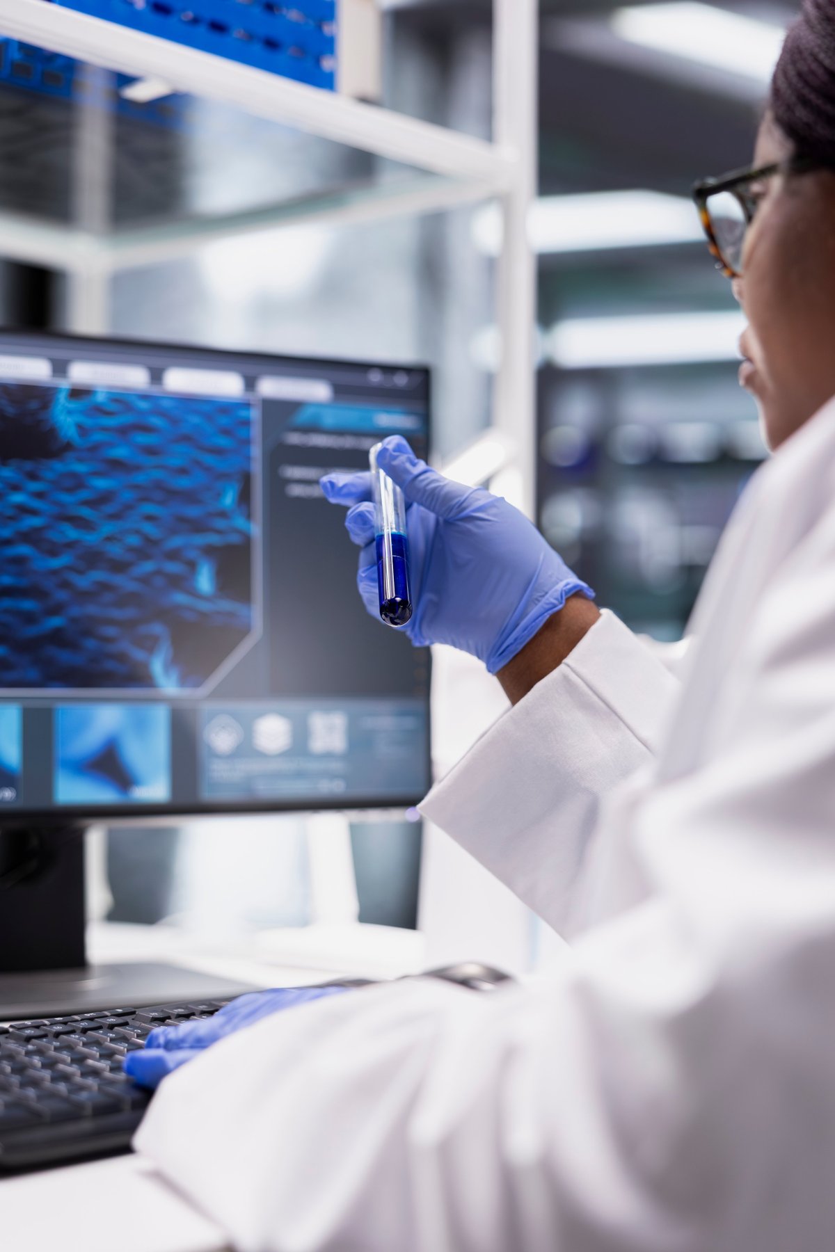 Scientist in a laboratory studying a DNA sample with modern equipment, representing regenerative science
